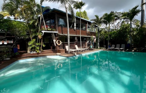 a pool with a house in the background