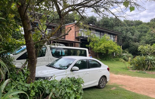 a white car parked in front of a house