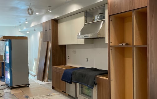 a kitchen with a refrigerator and cabinets in the middle of a room