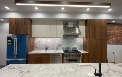 a kitchen with a marble counter top and a blue refrigerator