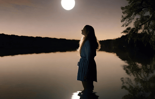 a lady water scrying at a lake in the moonlight