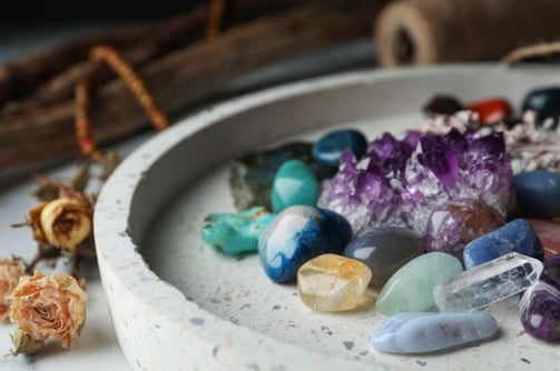 a bowl of crystals and crystals on a table