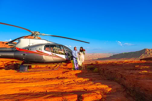 wedding couple walking by helicopter at valley of fire