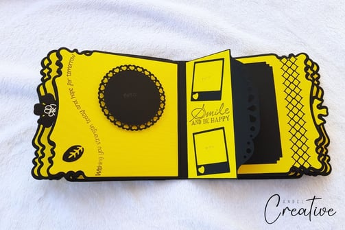 Decorative album page featuring yellow and black design elements. Includes photo frames, intricate b
