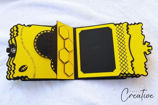 Yellow and black album page with honeycomb shapes and decorative borders. Includes a space for photo