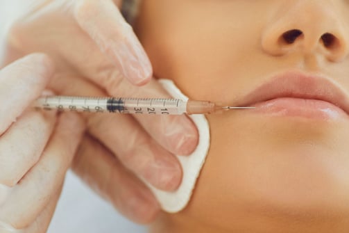 a woman getting a injection from a syll