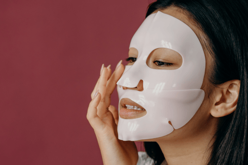 a woman with a white mask on her face for radiant glowing skin