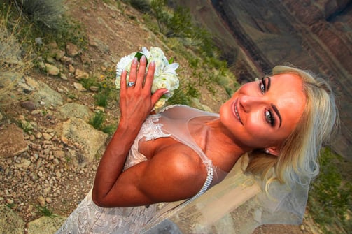 bride photo at grand canyon showing wedding ring and flowers