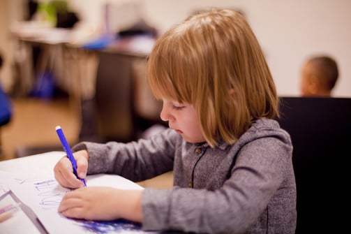 Schoolgirl sitting at her desk writing