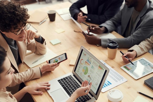 property managers working together at a table in front of computers