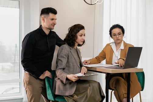 a property manager talking with clients at a table