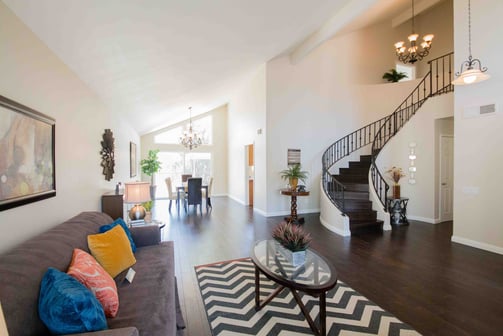 large living/dining area with elegant spiral staircase