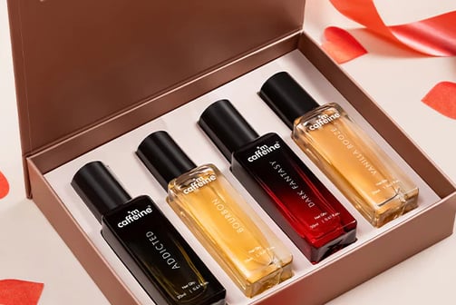 a box of perfumes with a red ribbon