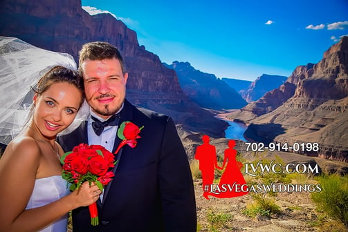 a man and woman standing in front of a mountain