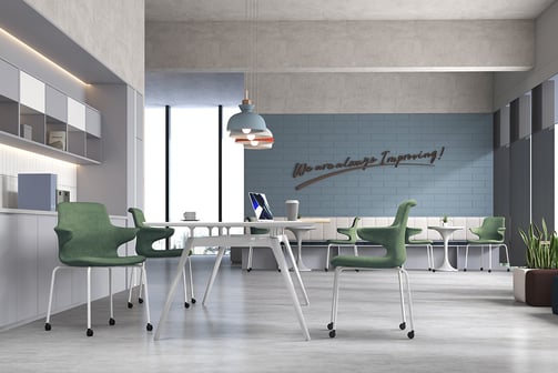 Green Dora chairs in a collaborative office with light flooring and wall art