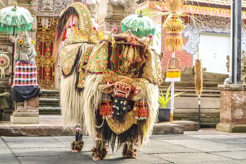 a man in a costume with a Barong Dance