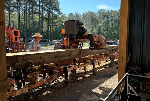 The Custom Sawyer sawmilling a 38 foot sinker cypress log with Woodmizer LT70 sawmill, in Rentz, GA