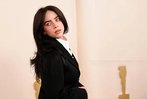 Billie Eilish in oversized Gucci attire at a 2025 Met Gala red carpet