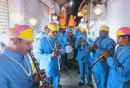 The Manohar Brass Band playing instruments in the narrow streets of Ajmer, adding musical charm to the atmosphere.