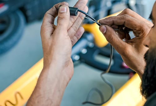 a man in a helmet is working on a piece of equipment