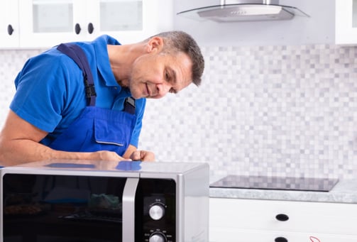 a man in a blue shirt and blue overall overall overall overall overall overall overall overall