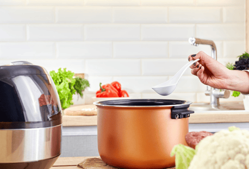 a person is cooking in a potted potted with a spoon
