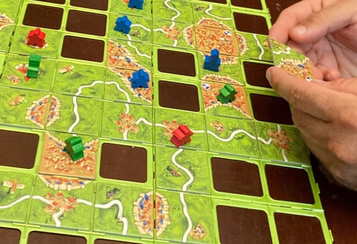 Getting ready to play a tile in Carcassonne the game
