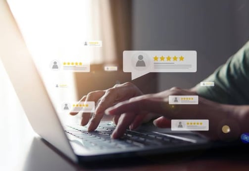 User actively engaging with customer feedback and star ratings on a laptop, representing online revi