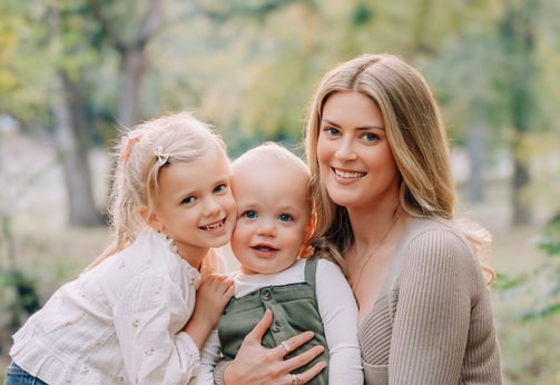 an adoption consultant woman and two young children posing for a photo