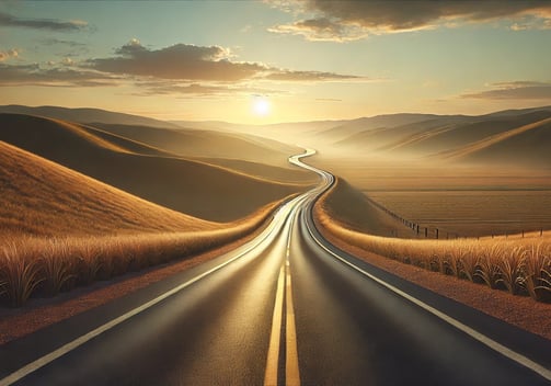 Road stretching into the horizon at golden hour, surrounded by hills, symbolizing personal growth and long-term purpose. 
