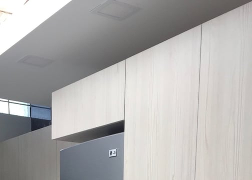 a kitchen with a refrigerator showcasing renewed cabinets