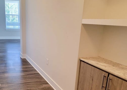 a kitchen with a wooden floor and a wooden cabinet