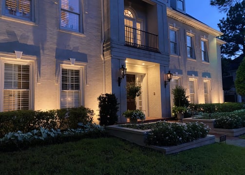 up lighting the front facade of a two story home