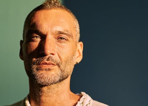 a man with a beard and a white shirt