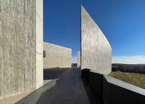 photographer landscape picture of a long narrow walkway with a long wall between two art structures