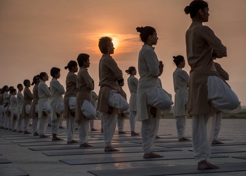 a group of people standing in a line doing Yoga