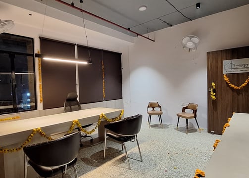 a room with a desk and chairs and a table