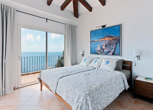 a bedroom with a large painting on the wall
