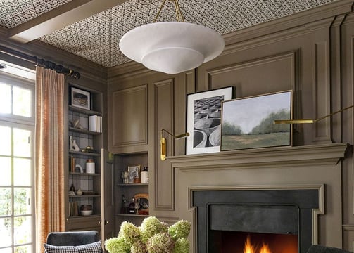 a living room with a fireplace and chairs
