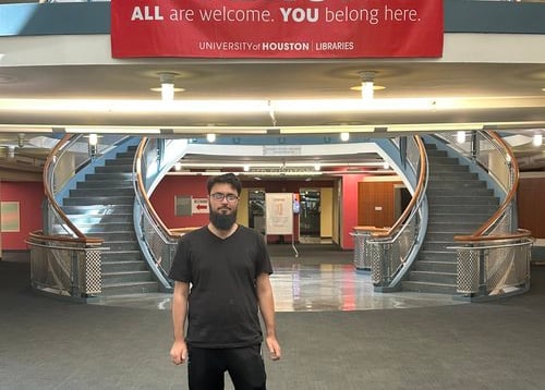 Koshish Foundation scholar standing outside a modern campus building.