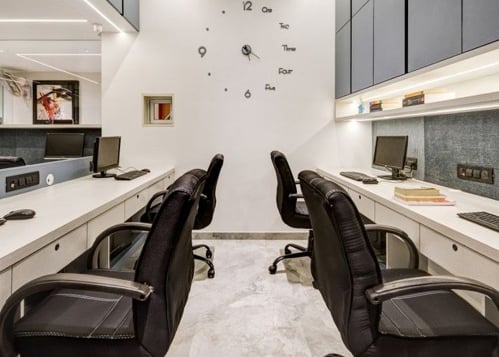 a large office with a long desk and chairs