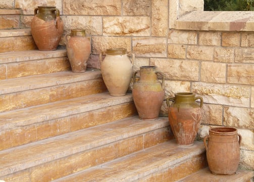 a bunch of vases with vases on the steps