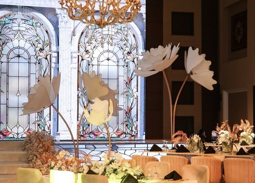 a large table in the front with a led screen in the back of an arches and stained glass