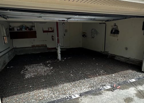 a garage with a garage door open and a garage door open