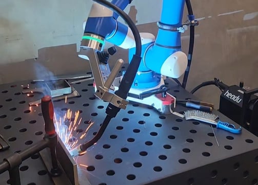 a robot is welding a metal frame