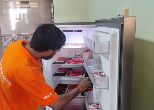 Appliance repair technician fixing a refrigerator in Jodhpur