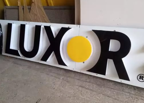 a large white sign with a yellow and black logo
