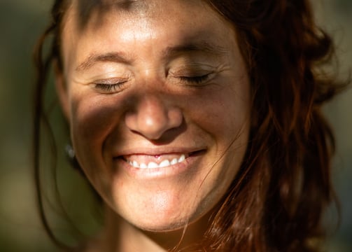 a woman with red hair and a smile on her face