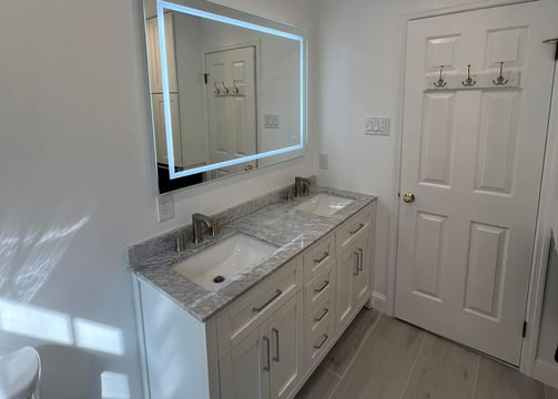 a new bathroom remodel with a large mirror and a sink