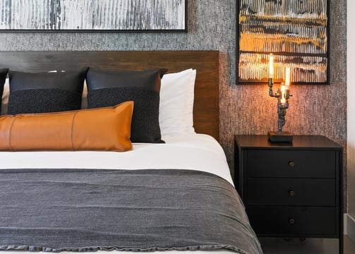 Elegant gray wallpaper accent wall in a modern bedroom, adding texture and sophistication to the space
